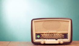Old retro radio with green eye light on table